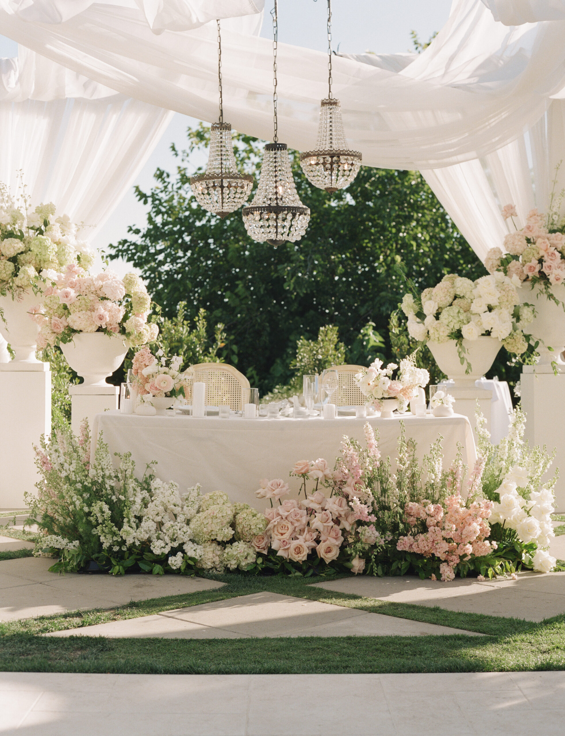 Romantic French-inspired wedding tablescape with lush floral centerpieces at Jeune Perché in Fallbrook, California